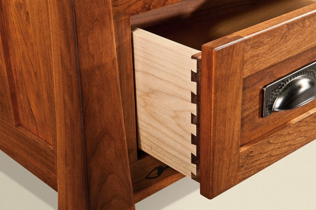 Close up of a drawer with Dovetail joints, with light and dark wood contrasts. 