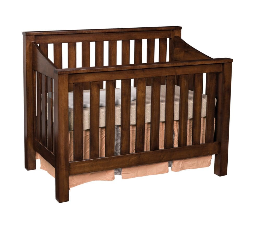 Mission Slat Crib made with brown hardwood and light pink bedding.
