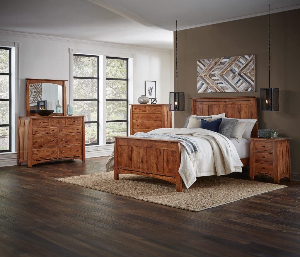 Brown stained hardwood queen bed in a room with matching dressers and a nightstand.