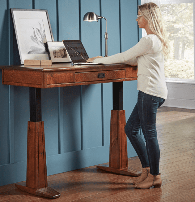 Girl at a grant sit-to-stand office desk in the standing position