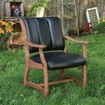 Midland accent chair with a stained hardwood frame and black leather upholstery.