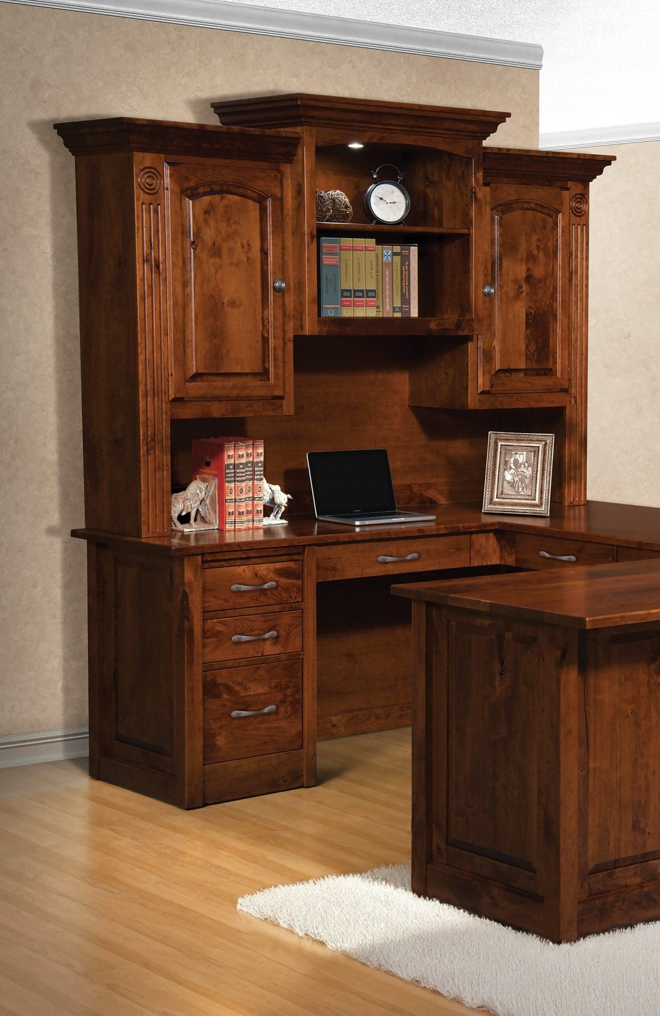 Large Victorian desk made from brown hardwood with cabinets, drawers, open shelves, and an L-shaped desk.