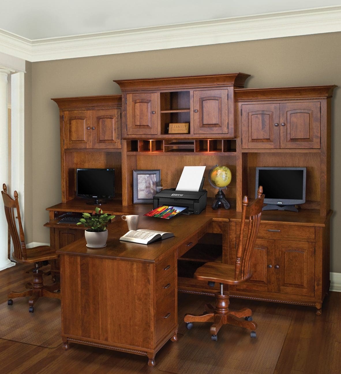 Large desk with a hutch and 2 sides with 2 chairs, 2 computers, a printer, and 2 L shape desks that meet in the middle.